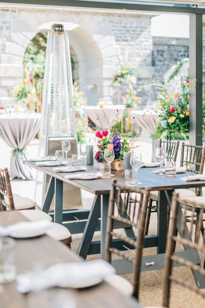 wooden table at a garden party with colorful flowers